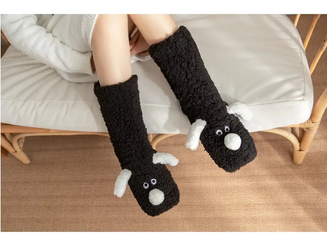 Cozy Dog Ear Socks in black worn by a seated person, with both white puppy faces visible