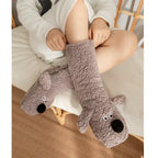 Cozy Dog Ear Socks in a gray style, with a seated wearer gently stretching the cuff
