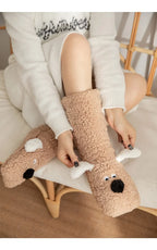 Cozy Dog Ear Socks in khaki in a close-up of a seated wearer lifting the white ears