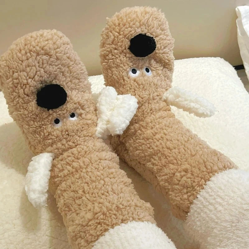 Cozy Dog Ear Socks in khaki, shown on raised feet against soft white bedding