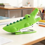 Crocodile Mini Stapler on a white classroom desk beside pencils and stacked notebooks
