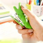 Crocodile Mini Stapler held in one hand, showing its compact green crocodile shape