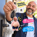 Smiling man displaying a photo face belly keychain on his keys