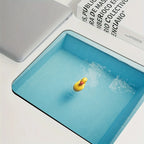 Cute Duck Desk Mat compact blue pool-print mouse pad with a yellow duck pictured beside a laptop and book