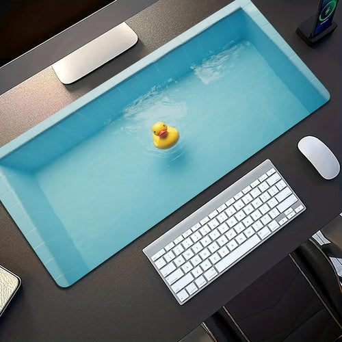 Cute Duck Desk Mat blue pool-and-yellow-duck print shown diagonally on a dark desk beside a keyboard and mouse