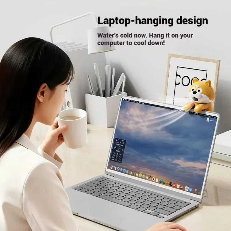 Cute Food Cooling Fan hanging from a laptop screen beside a person holding a mug