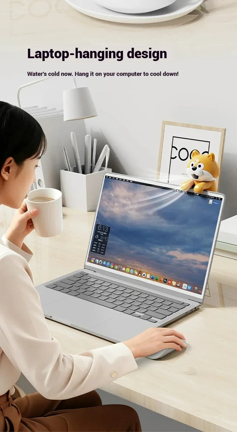 Cute Food Cooling Fan perched on a laptop screen while a person works and holds a mug