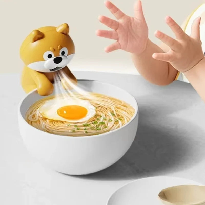 Cute Food Cooling Fan hanging on a noodle bowl beside a child, with illustrated airflow