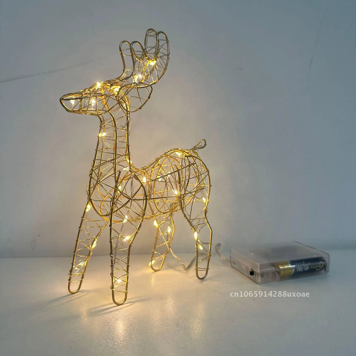 Cute Lighted Wire Reindeer with a gold-tone frame, warm lights and an attached clear battery box