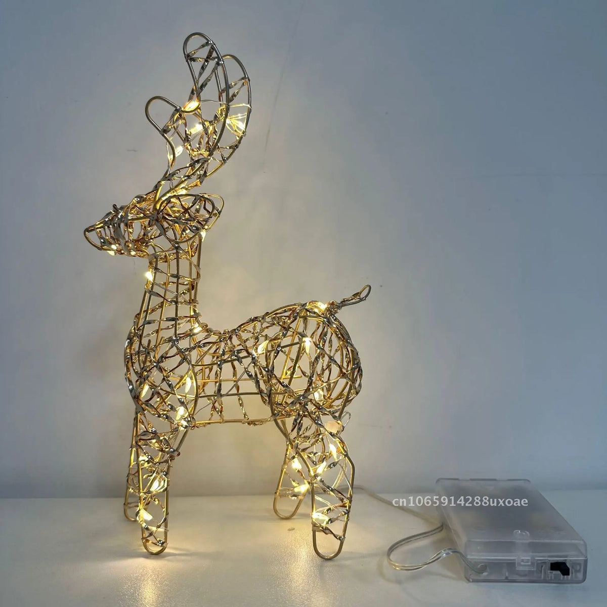 Cute Lighted Wire Reindeer showing the reflective metal-strip design illuminated beside its battery box