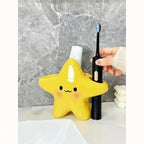 Cute Star Toothbrush Holder with a hand placing a black electric toothbrush into the side opening