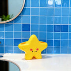 Cute Star Toothbrush Holder displayed empty on a white bathroom counter against bright blue tile