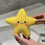 Cute Star Toothbrush Holder shown empty by hand above a bathroom sink, revealing its yellow star shape