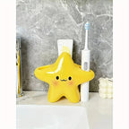 Cute Star Toothbrush Holder holding a white electric toothbrush and toothpaste beside a bathroom sink