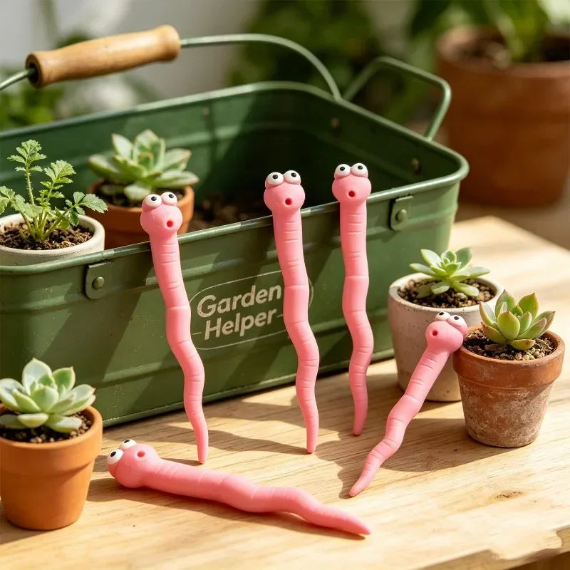 Cute Worm Plant Ornaments: five pink worms arranged beside a green garden caddy and small potted succulents.