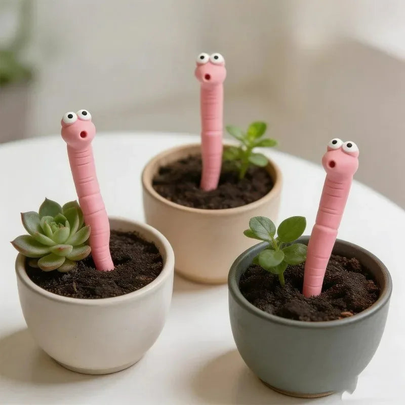 Cute Worm Plant Ornaments: three pink worms decorating small cream, beige and gray-green succulent pots.