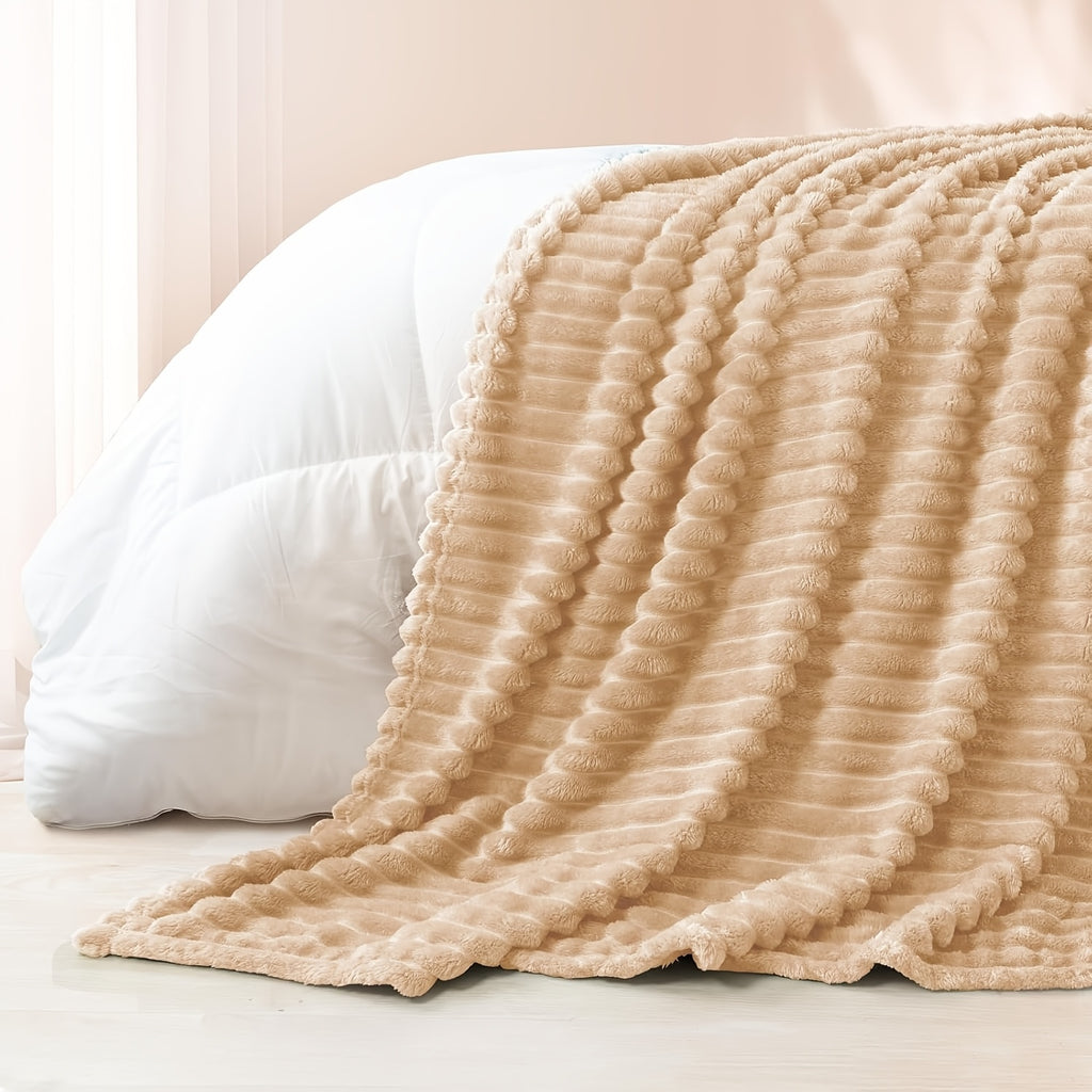 Cozy Fuzzy Blanket in beige with ribbed texture draped over white bedding, showcasing plush faux fur texture