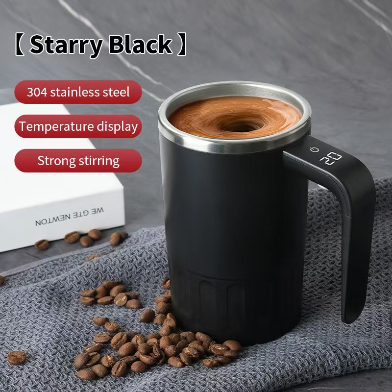 Digital Self-Stirring Mug black mug with a swirling coffee drink, handle display and coffee beans on gray fabric.