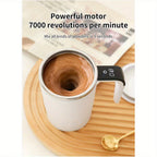 Digital Self-Stirring Mug white mug and stirring feature graphic on a wooden tray beside a gold-colored spoon.