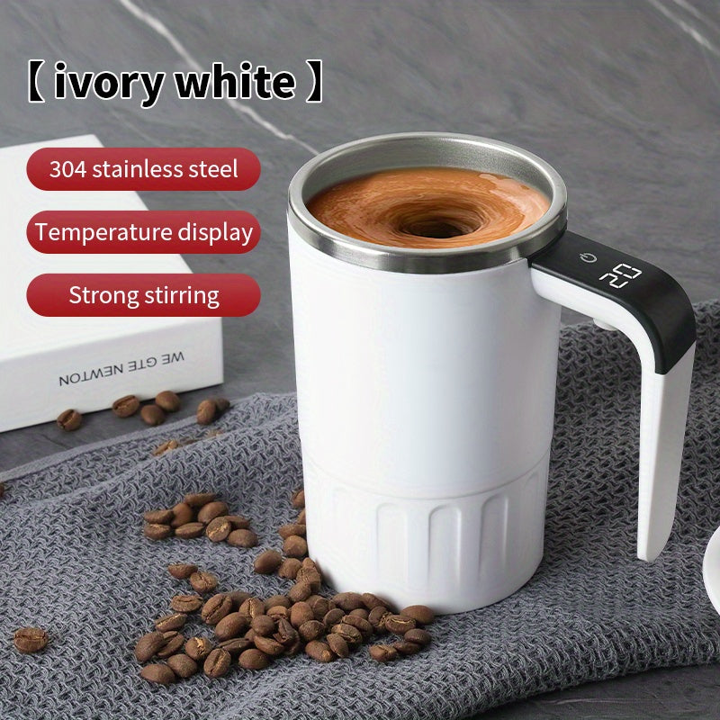 Digital Self-Stirring Mug white mug stirring a drink on gray fabric, with the digital handle display visible.