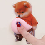 Dog Belly Door Buffer close-up with a finger pressing the soft pink silicone belly