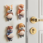 Dog Belly Door Buffer four-design assortment mounted beside a white door with gold hardware