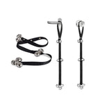 Black dog training bell strap shown flat and hanging from a lever handle and round doorknob