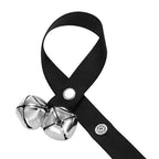 Close-up of black nylon hanging loop, metal snaps, and silver dog training bells