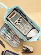 Double Compartment Pencil Case close-up of the blue main compartment with a calculator and small stationery.