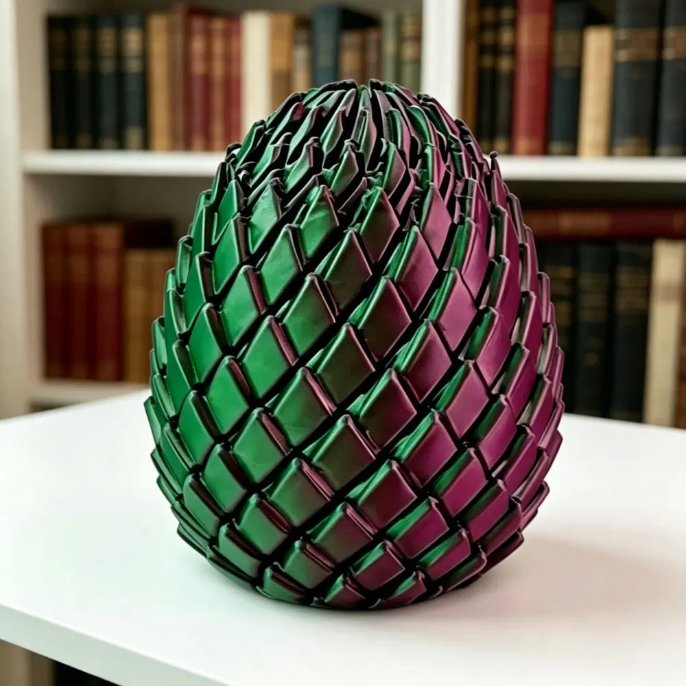 Dragon Egg Fidget Toy in green and purple displayed upright on a white desk by bookshelves