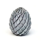 Dragon Egg Fidget Toy in silver shown upright with its layered scale texture clearly visible