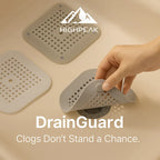 HighPeak DrainGuard™ gray silicone drain cover with suction grip catching hair in a bathroom sink drain