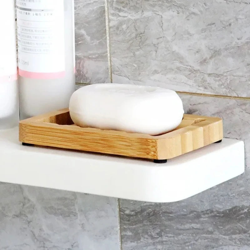 Draining Bamboo Soap Dish holding white bar soap on a bathroom shower shelf