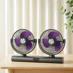 Front view of the charcoal Dual Head Portable Fan with purple blades on a wooden table