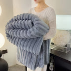 Cozy Fuzzy Blanket in plush gray faux fur with ribbed texture, folded to display luxurious double-sided warmth