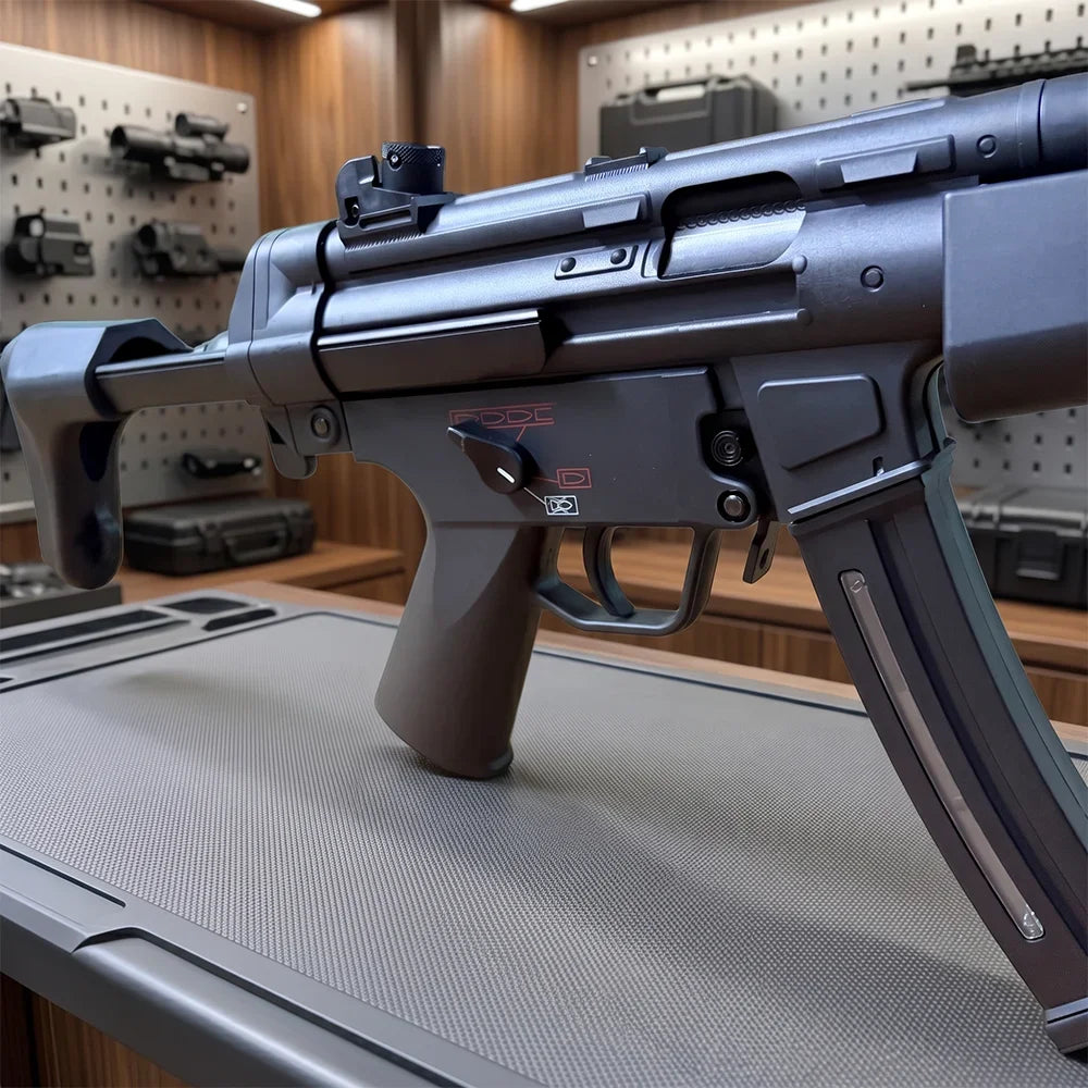 Electric SMG Gel Blaster close-up showing the black receiver, trigger, selector, and curved magazine