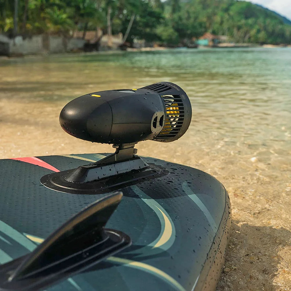 Electric Underwater Scooter installed as a paddle board motor beside calm shoreline water