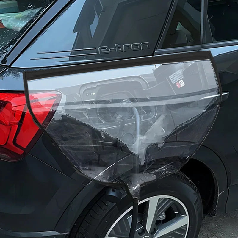 EV Charging Rain Cover — Black-edged transparent cover over the side charging port of a dark vehicle.