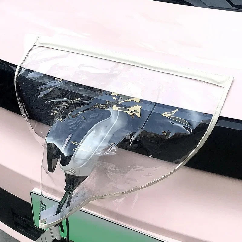 EV Charging Rain Cover — White-edged clear cover over a front charging connector on a pink car.