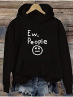 "Ew, People" Hoodie in black hanging above denim shorts with the white graphic centered