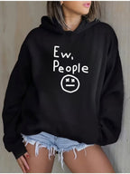 "Ew, People" Hoodie in black modeled against a neutral wall with the graphic fully visible
