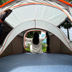 Family Pop-Up Tent interior showing the floor, mesh windows and a camper seated at the opposite doorway.