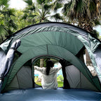 Family Pop-Up Tent green demonstration interior with a camper at the doorway; the available option is brown.