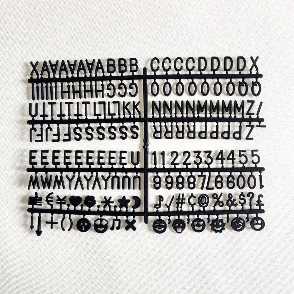 Felt Letter Board black replacement letter and symbol set arranged on its plastic sheet.
