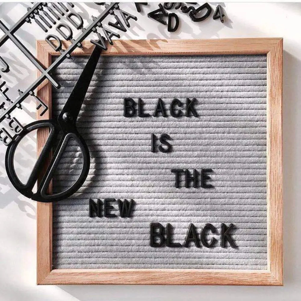 Felt Letter Board in gray with black letters being separated from the sheet with scissors.