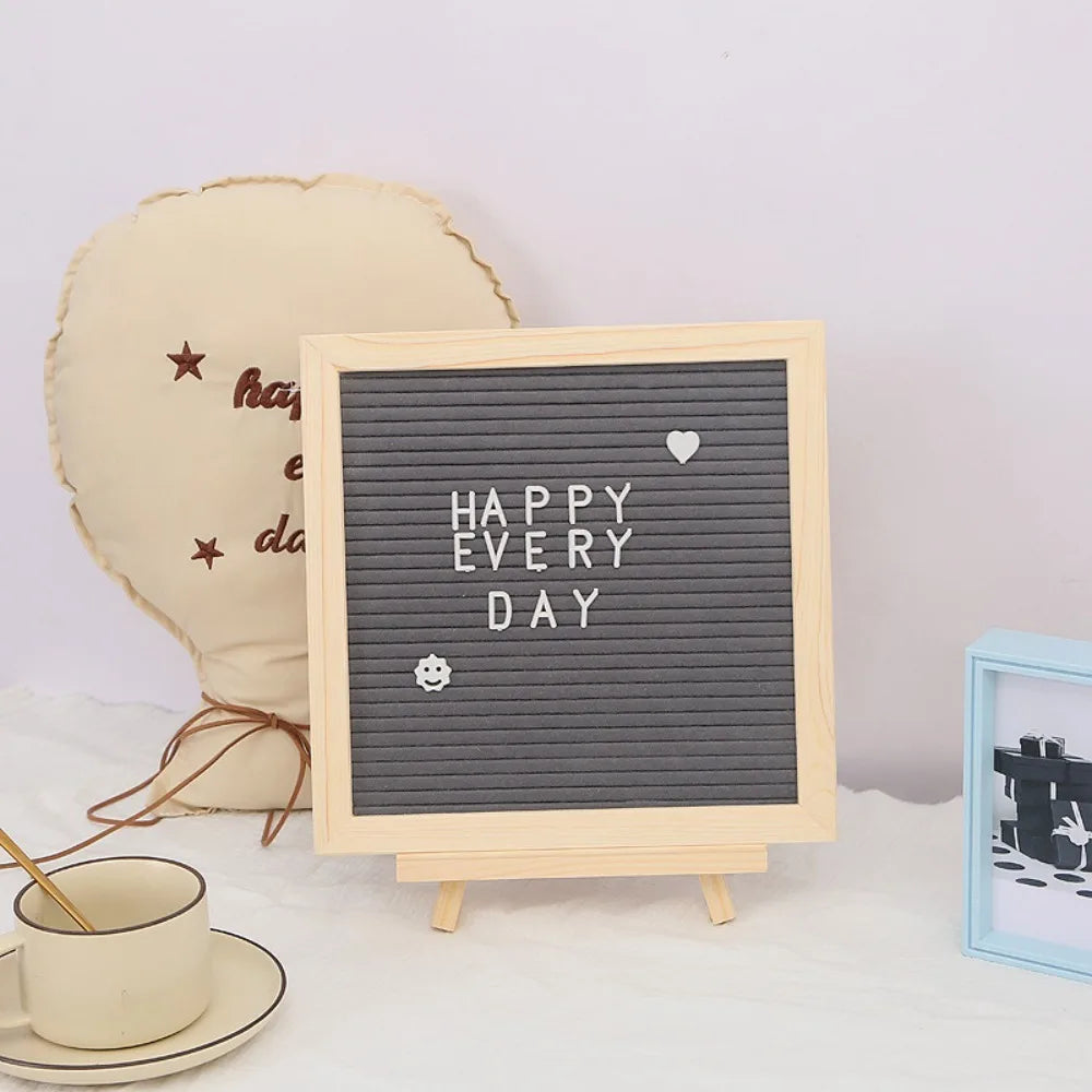Felt Letter Board in gray with white letters and symbols displayed on the optional wooden stand.