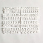 Felt Letter Board white replacement letter and symbol set arranged on its plastic sheet.