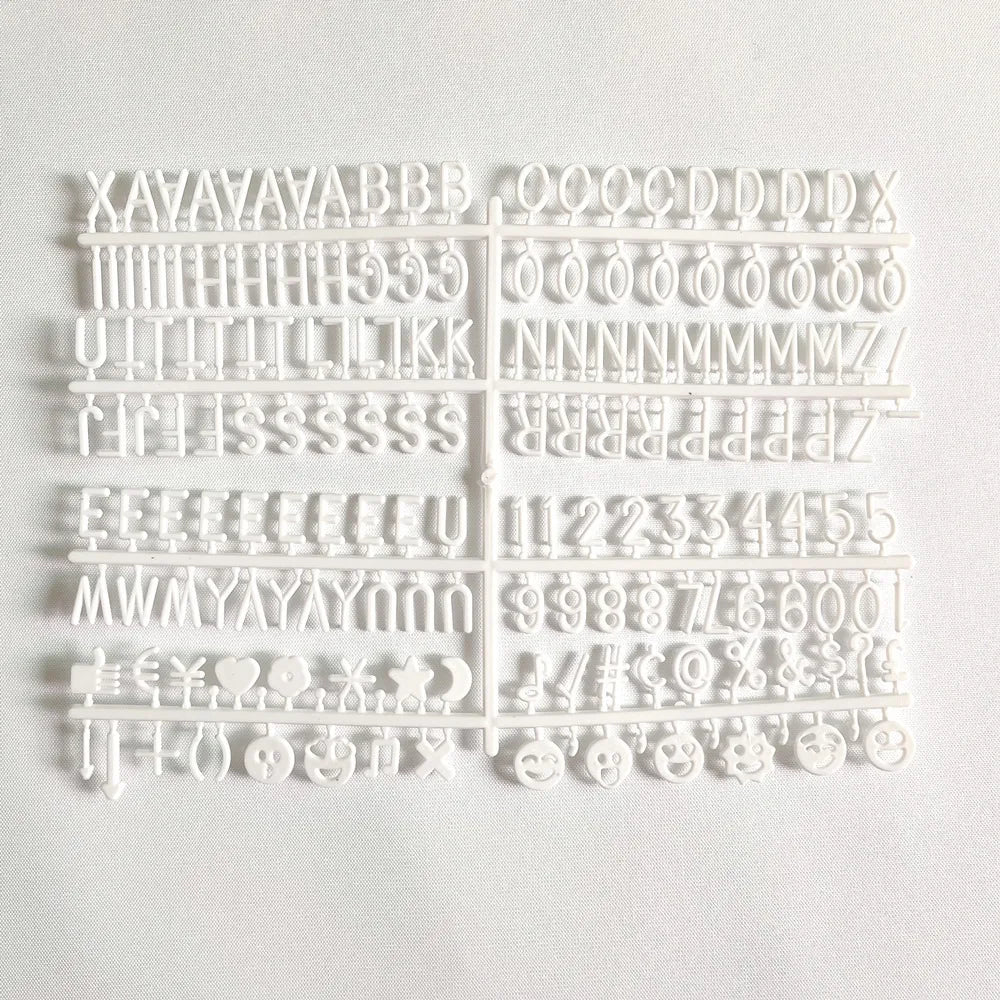 Felt Letter Board white replacement letter and symbol set arranged on its plastic sheet.
