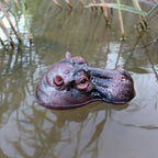 Floating Hippo Pond Decor right-facing side profile of the brown resin hippo head floating on rippling pond water.