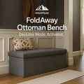 HighPeak FoldAway Ottoman Bench in gray fabric with hidden storage and padded seat in a cozy entryway setting.